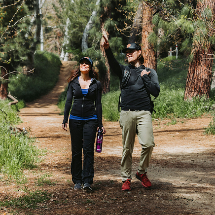 Two people hiking and smiling